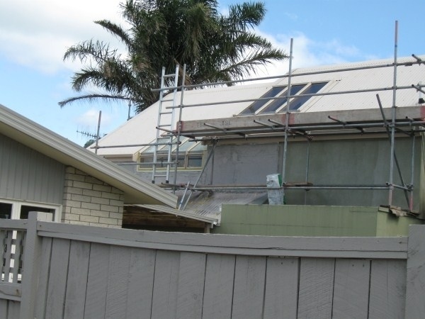 Photo of paint scaffolding set up on a house ready for the pre-paint washing service provided by Ewash.