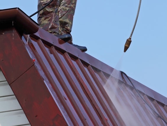 Photo of a roof being waterblasted as part of the roof cleaning service provided by Ewash.